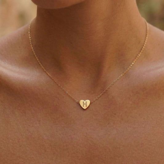 Woman wearing gold 3D heart charm necklace - Calioras