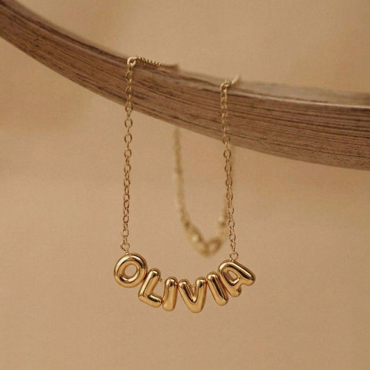 Close-up of 3D bubble letter pendant in gold - Calioras