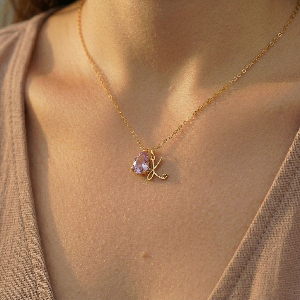 Woman wearing gold teardrop birthstone necklace - Calioras
