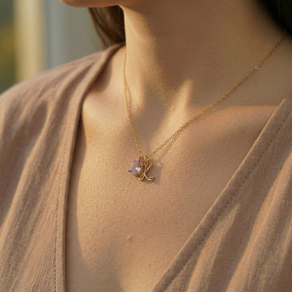 Close-up of teardrop pendant with birthstone and initial - Calioras