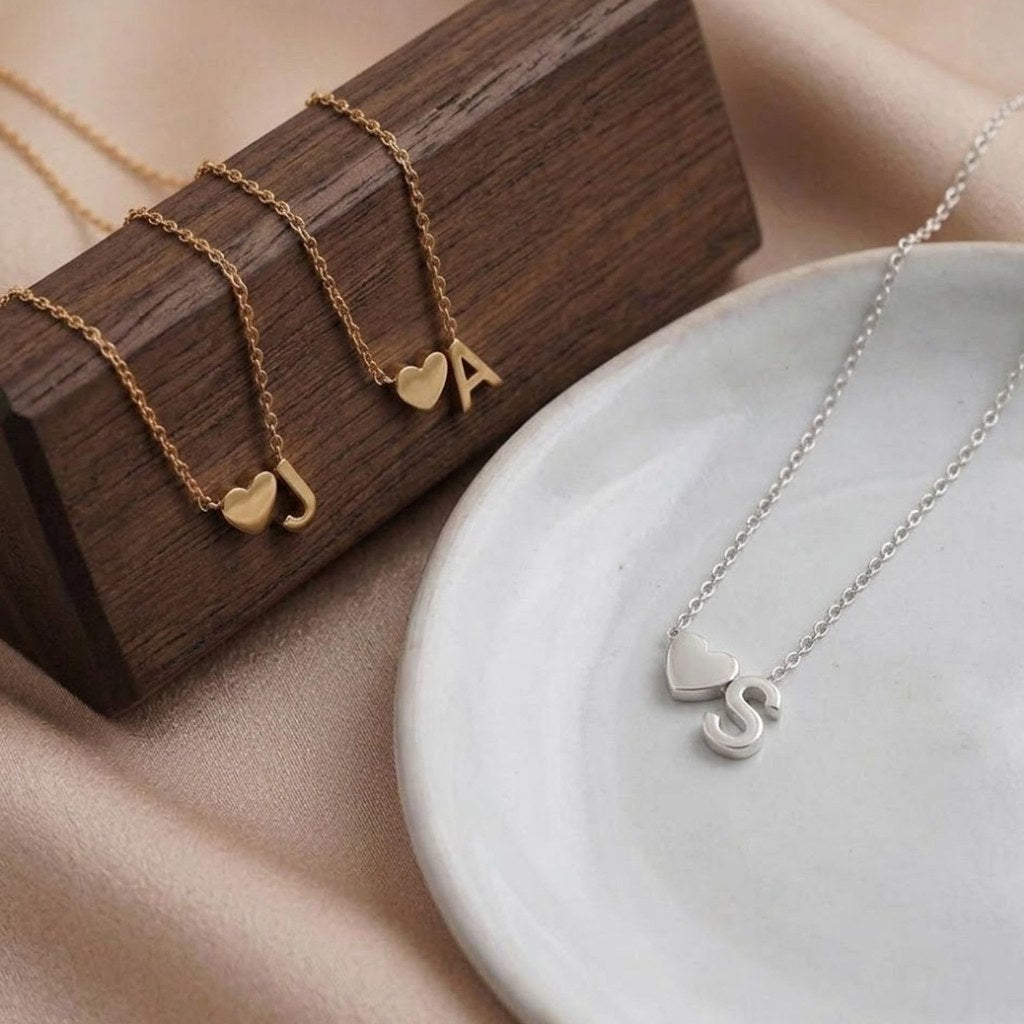 Close-up of dainty heart pendant with initial - Calioras
