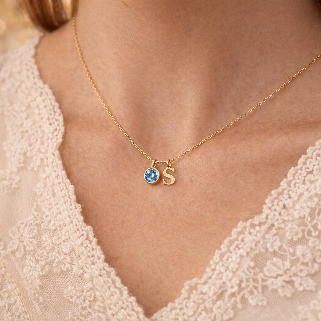 Woman wearing gold birthstone initial necklace - Calioras
