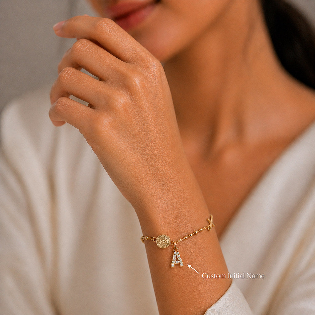 Close-up of Virgin Mary and cross charm in gold - Calioras
