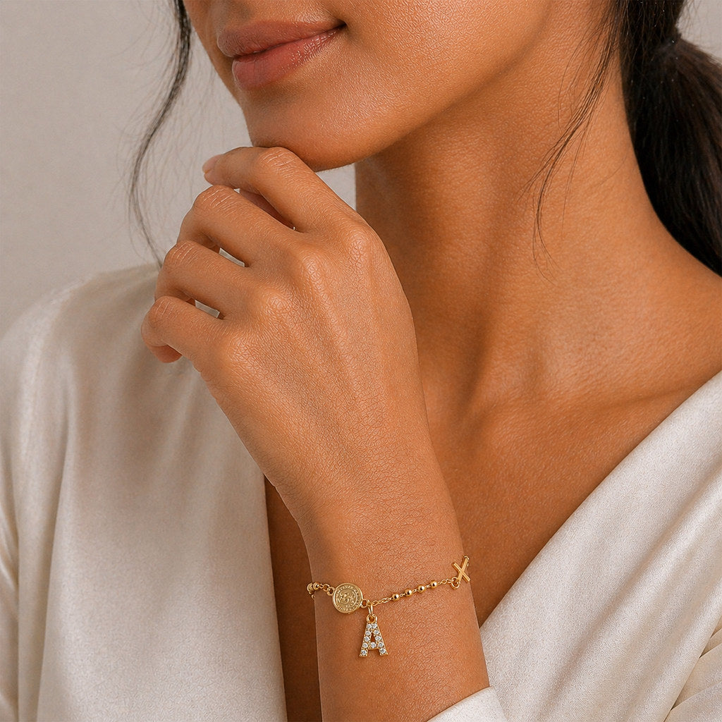 Woman wearing gold Virgin Mary cross bracelet - Calioras