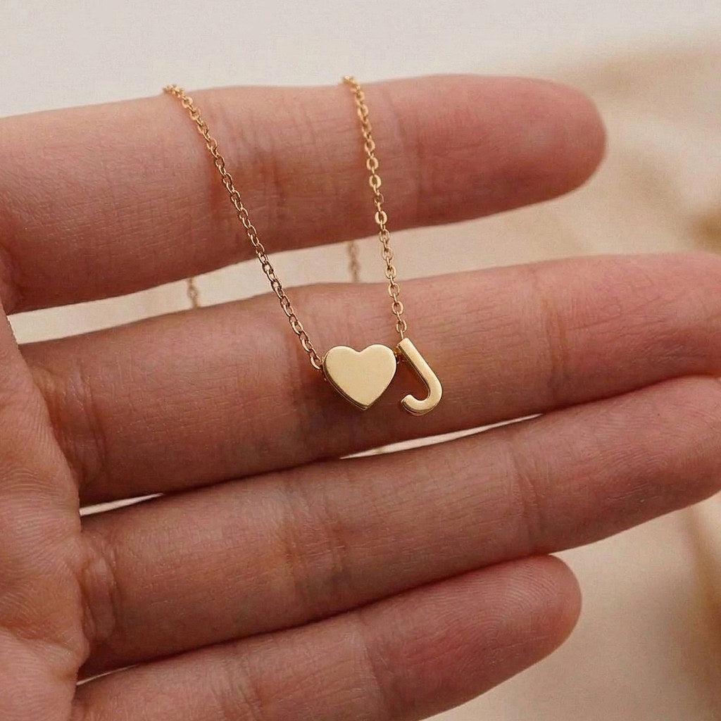 Close-up of dainty heart pendant with initial - Calioras
