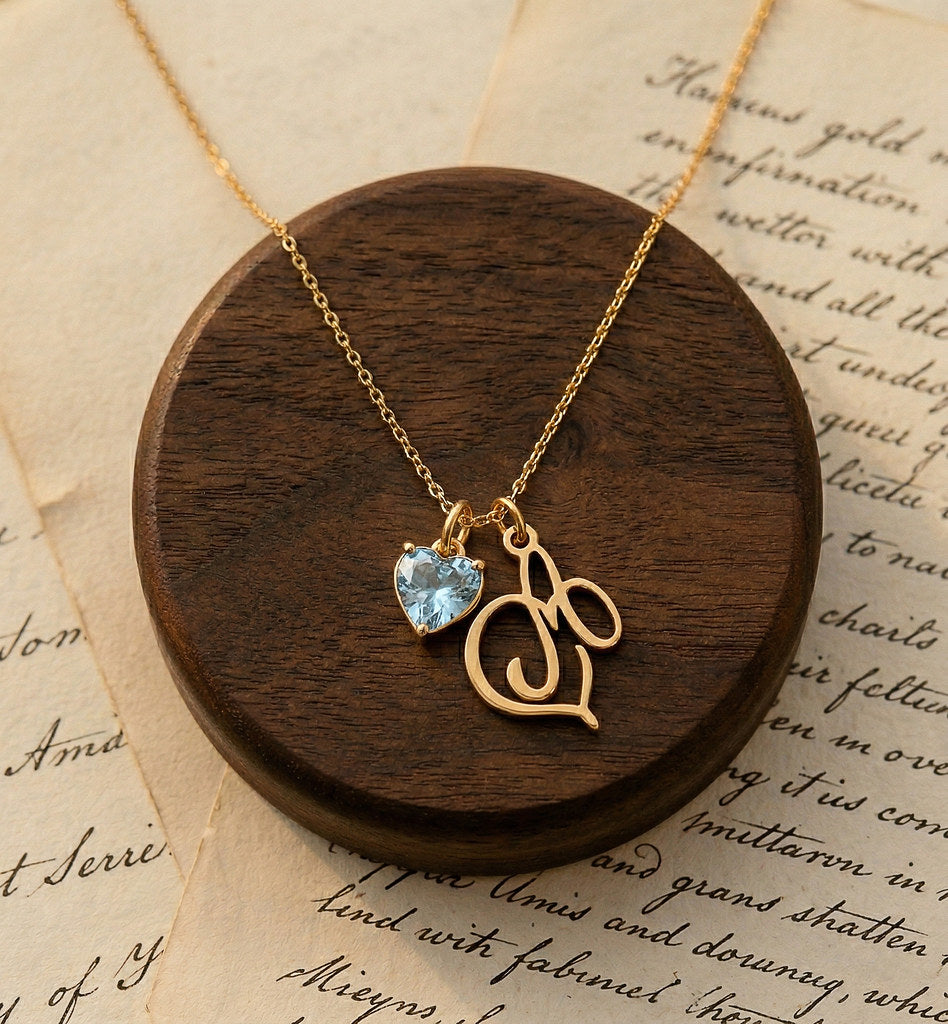 Close-up of heart pendant with birthstone and initial - Calioras
