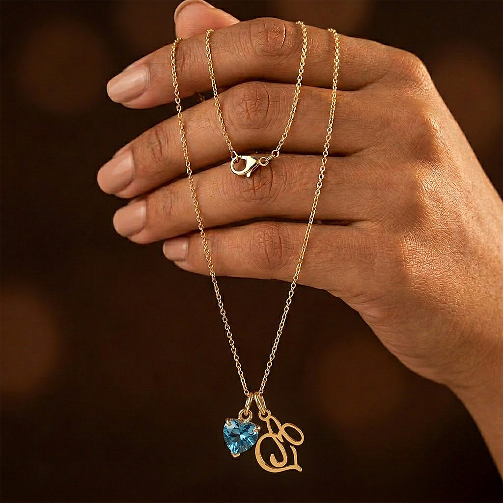 Close-up of heart pendant with birthstone and initial - Calioras

