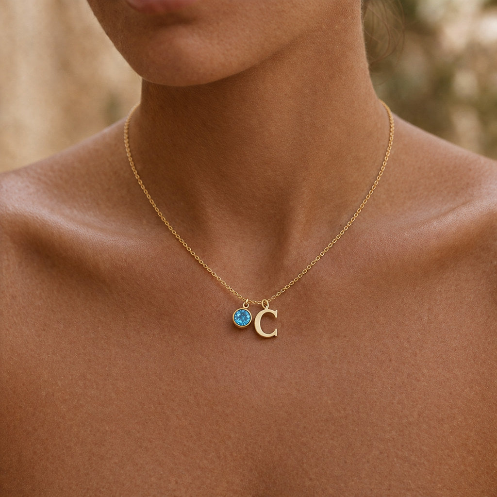 Woman wearing gold birthstone initial necklace - Calioras
