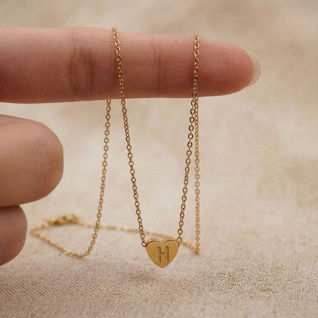 Close-up of 3D heart charm with initial in gold - Calioras