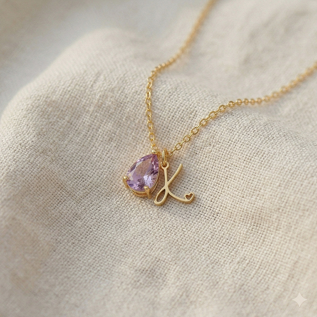 Close-up of teardrop pendant with birthstone and initial - Calioras
