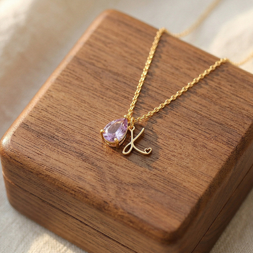 Close-up of teardrop pendant with birthstone and initial - Calioras