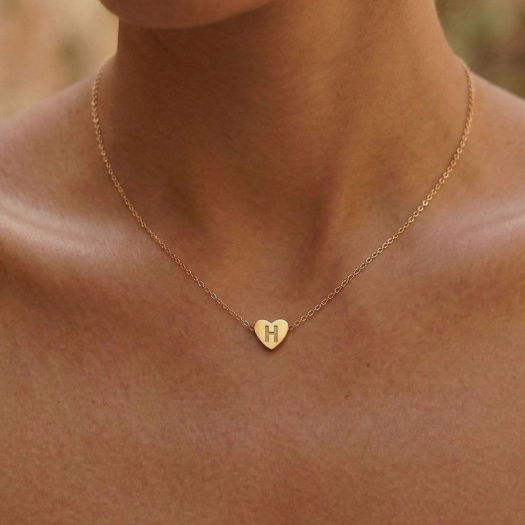 Woman wearing gold 3D heart charm necklace - Calioras