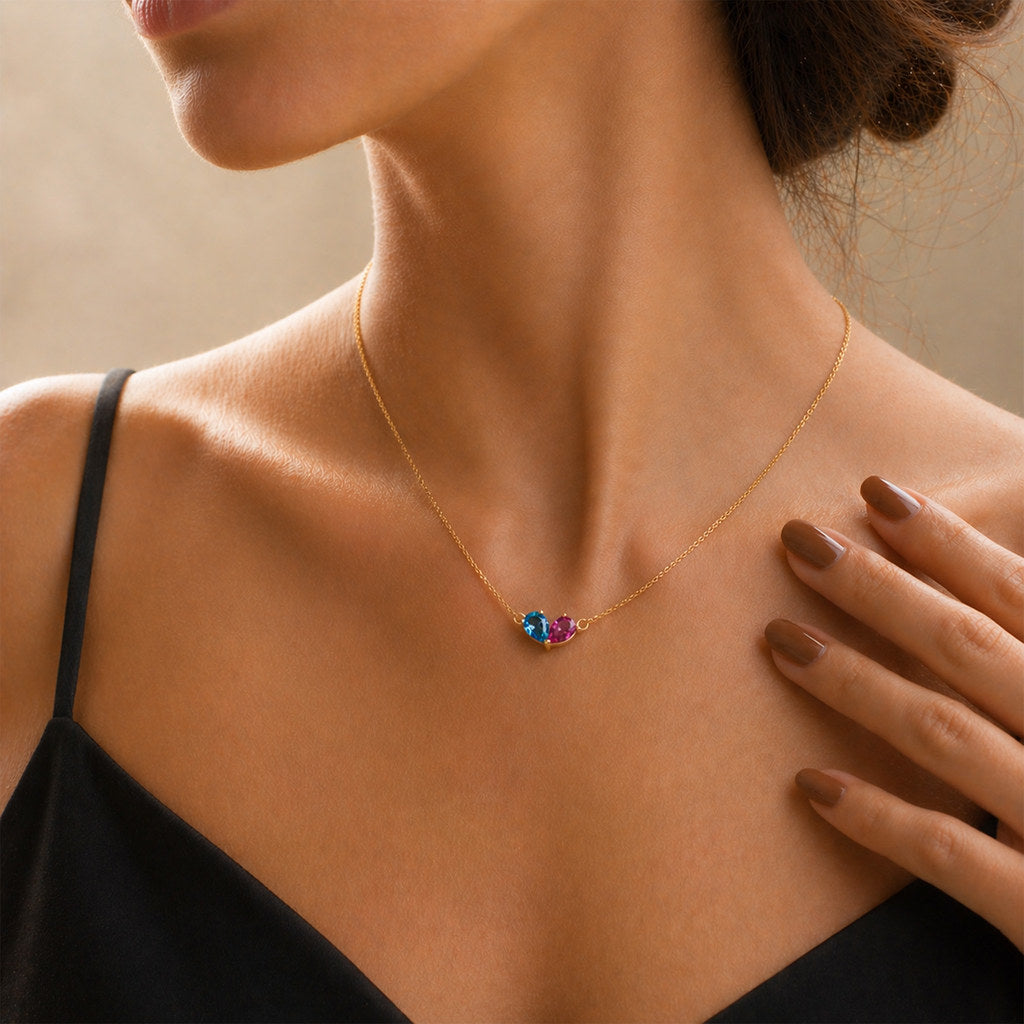 Woman wearing gold heart birthstone necklace - Calioras