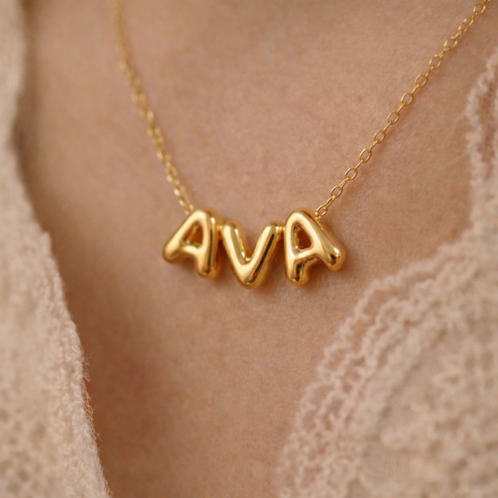 Woman wearing gold bubble letter necklace - Calioras