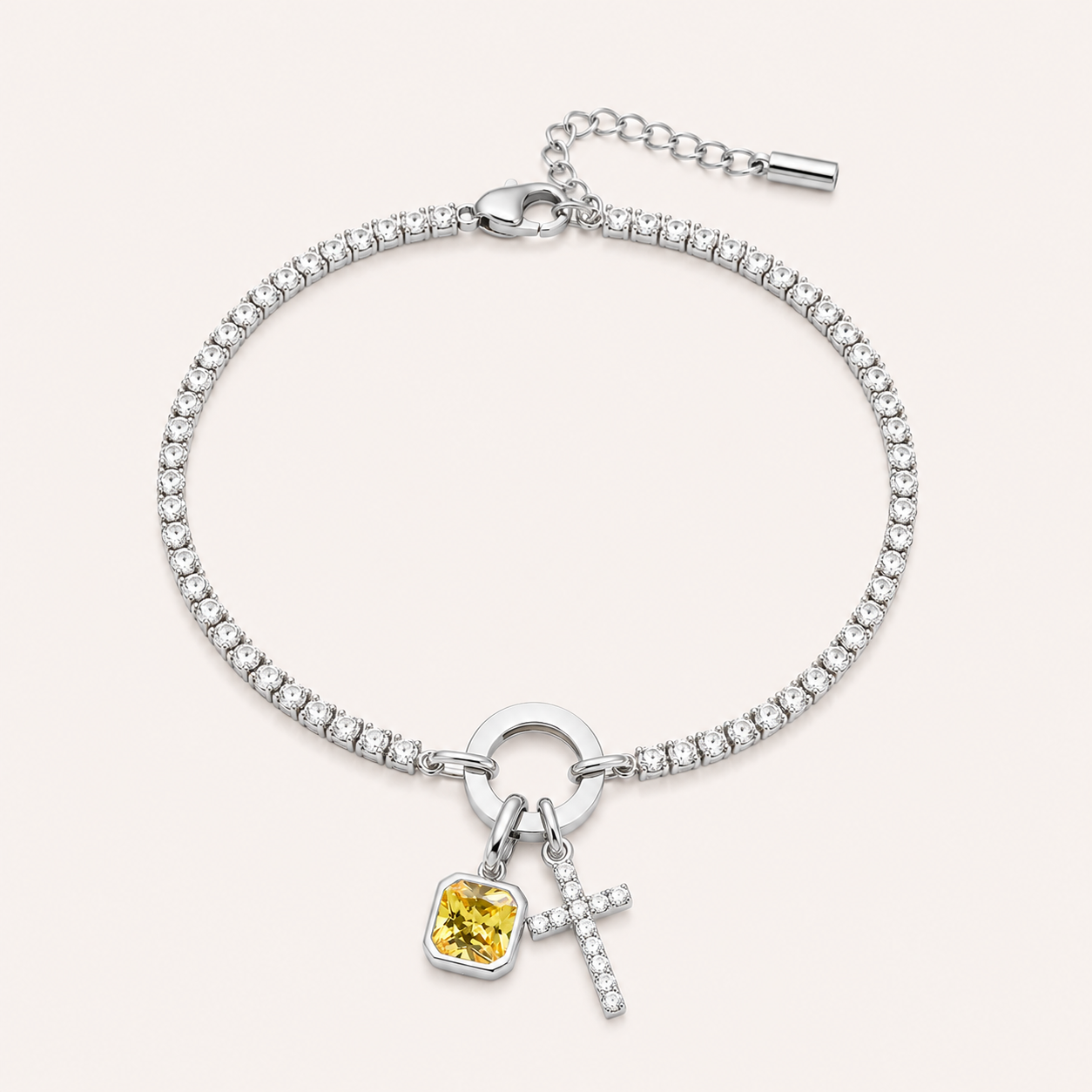 Silver tennis birthstone cross bracelet with CZ cross charm and yellow birthstone
