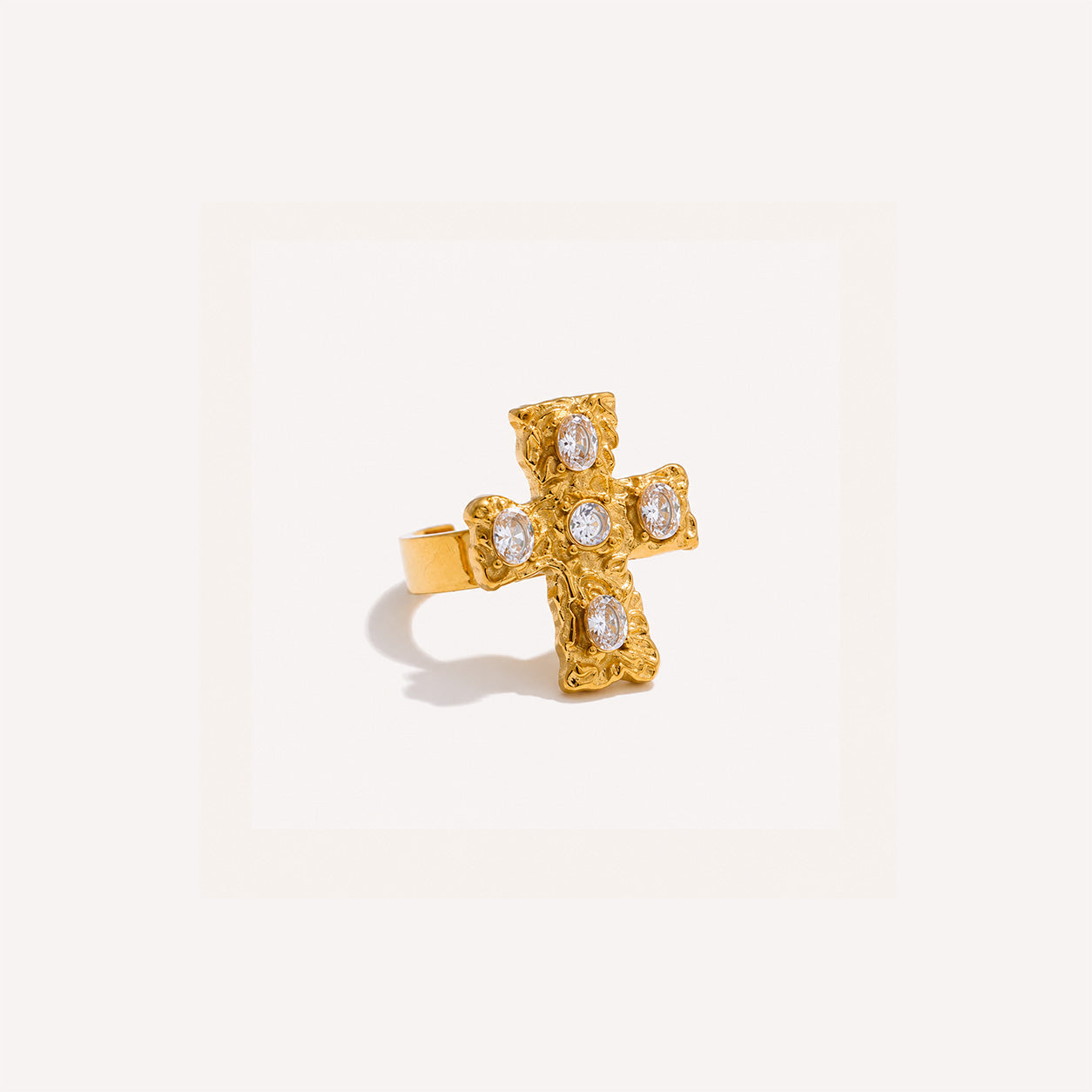 Baroque cross ring in white finish with ornate cross on cream background