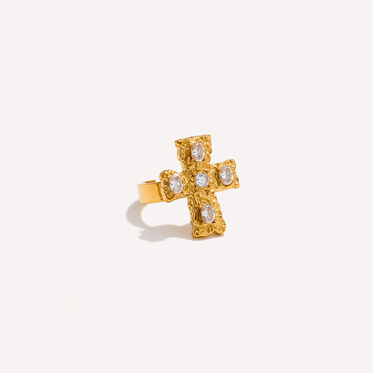 Baroque cross ring in white finish with ornate cross on cream background