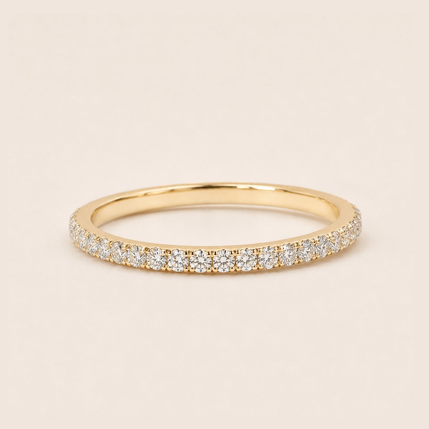 18K gold full pave CZ eternity ring dainty stackable band on cream background