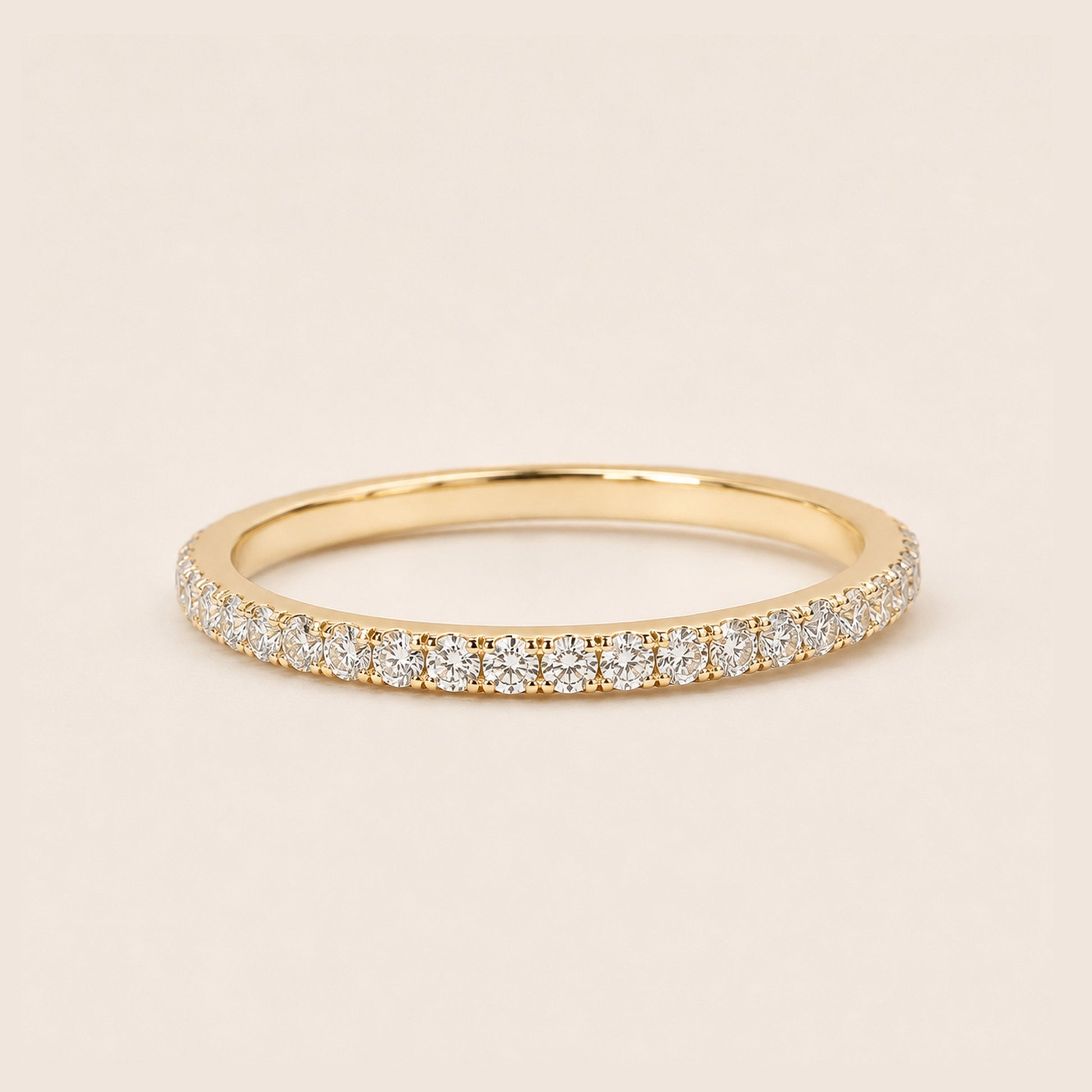 18K gold full pave CZ eternity ring dainty stackable band on cream background