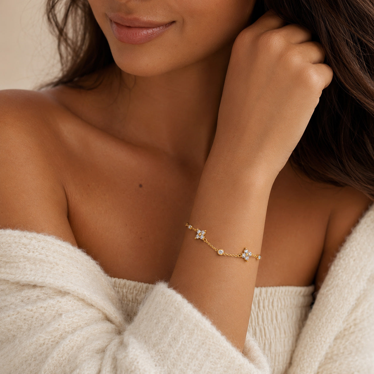 Woman wearing gold crystal blossom station bracelet on wrist