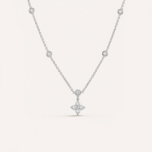 Tiny puffed plain cross necklace in silver on cream background