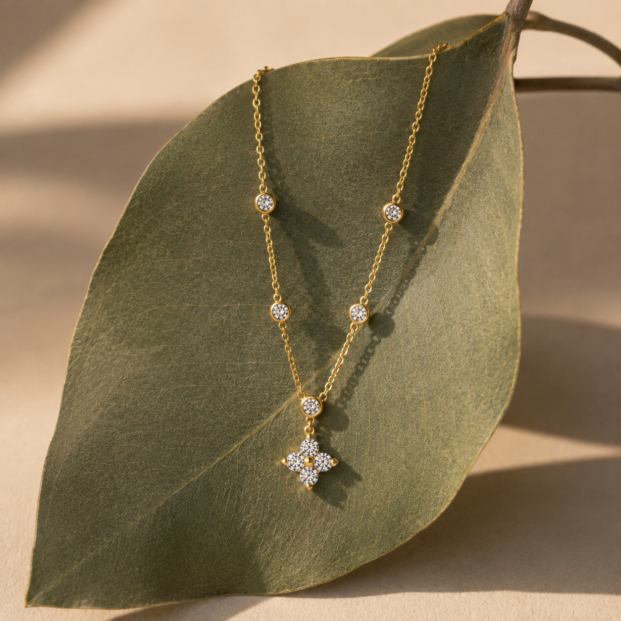 Crystal blossom station necklace draped over cream ceramic still life