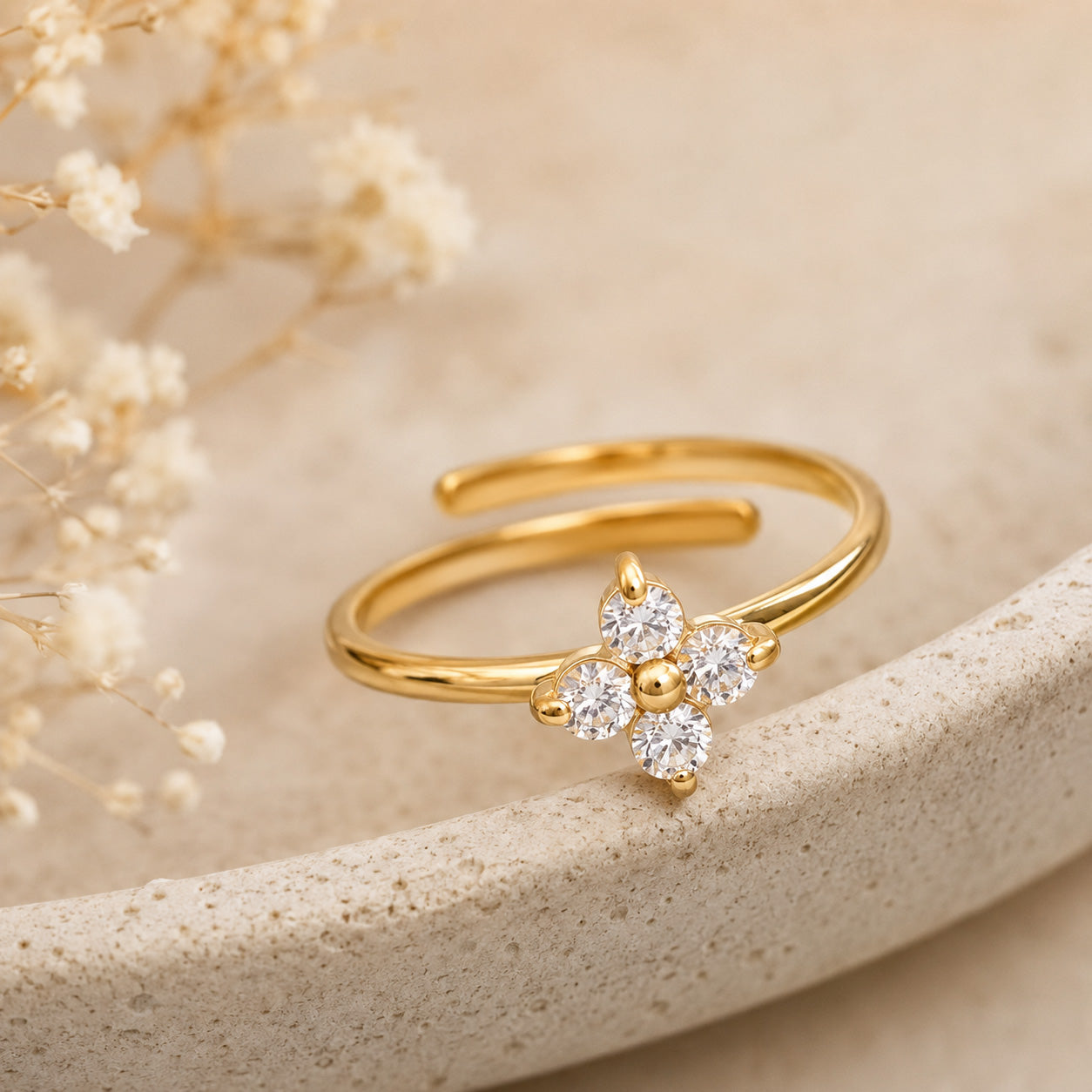 Crystal blossom ring resting on cream ceramic still life