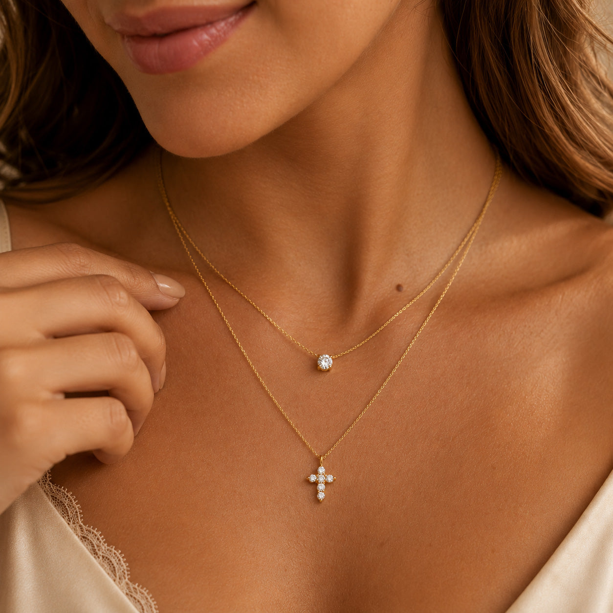 Side view of gold double layer crystal and petal cross necklace on woman's neck