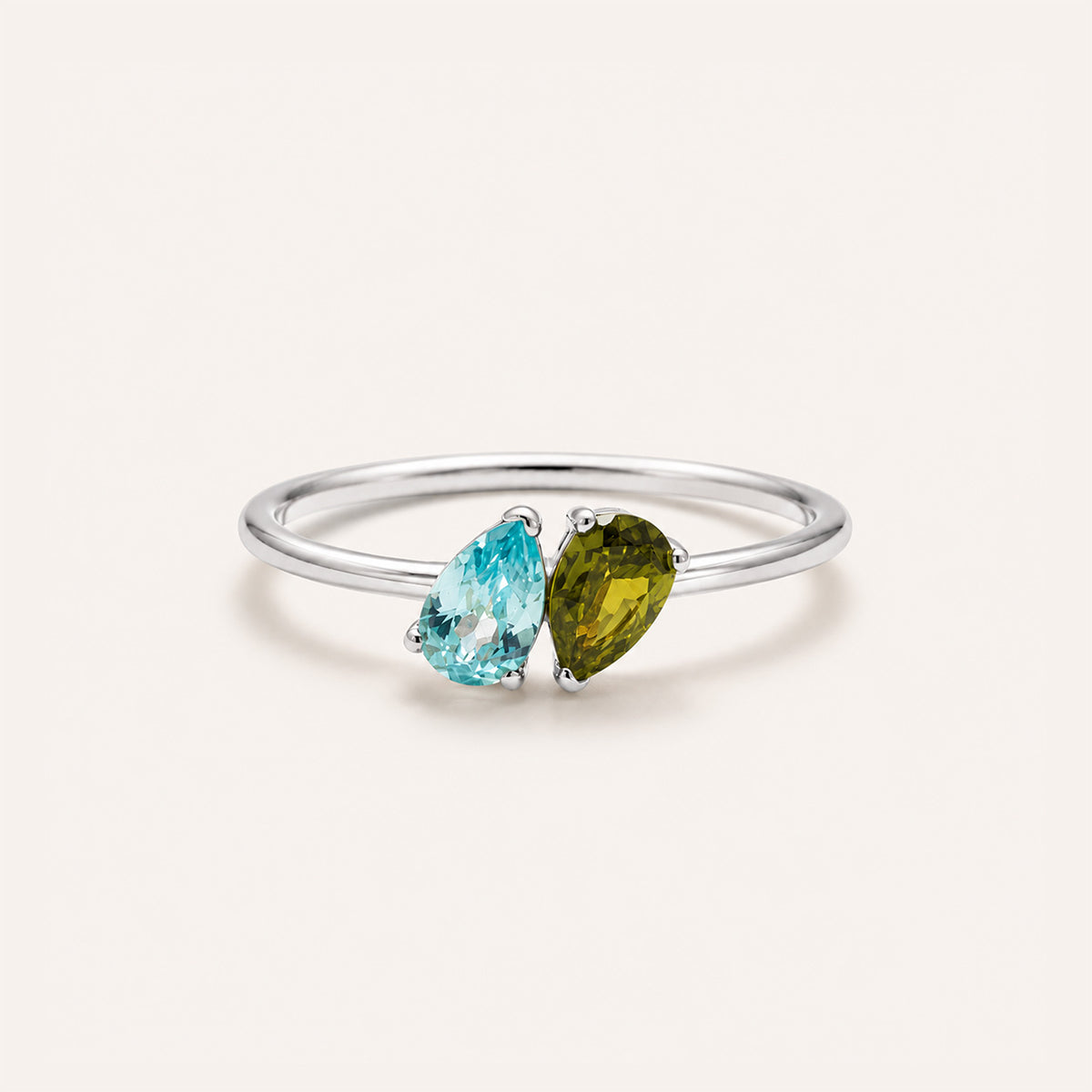 Toi et moi birthstone ring in silver with two pear stones on cream background