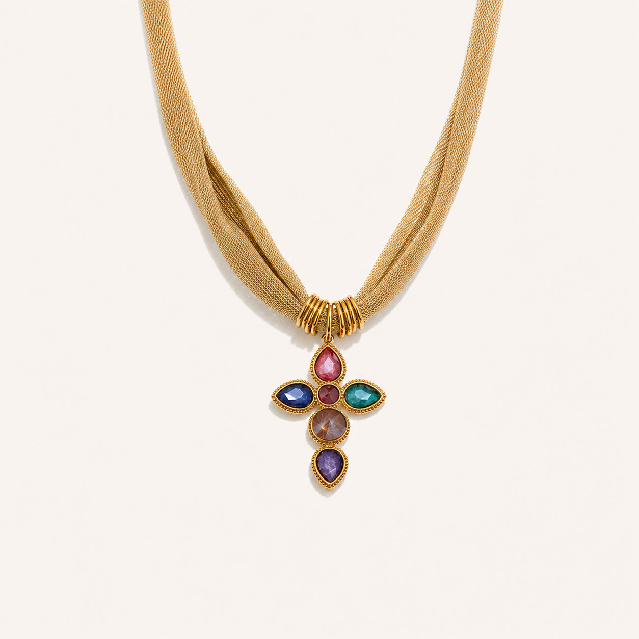 Vintage mesh cross necklace with large rainbow crystal cross in 18K gold on cream background